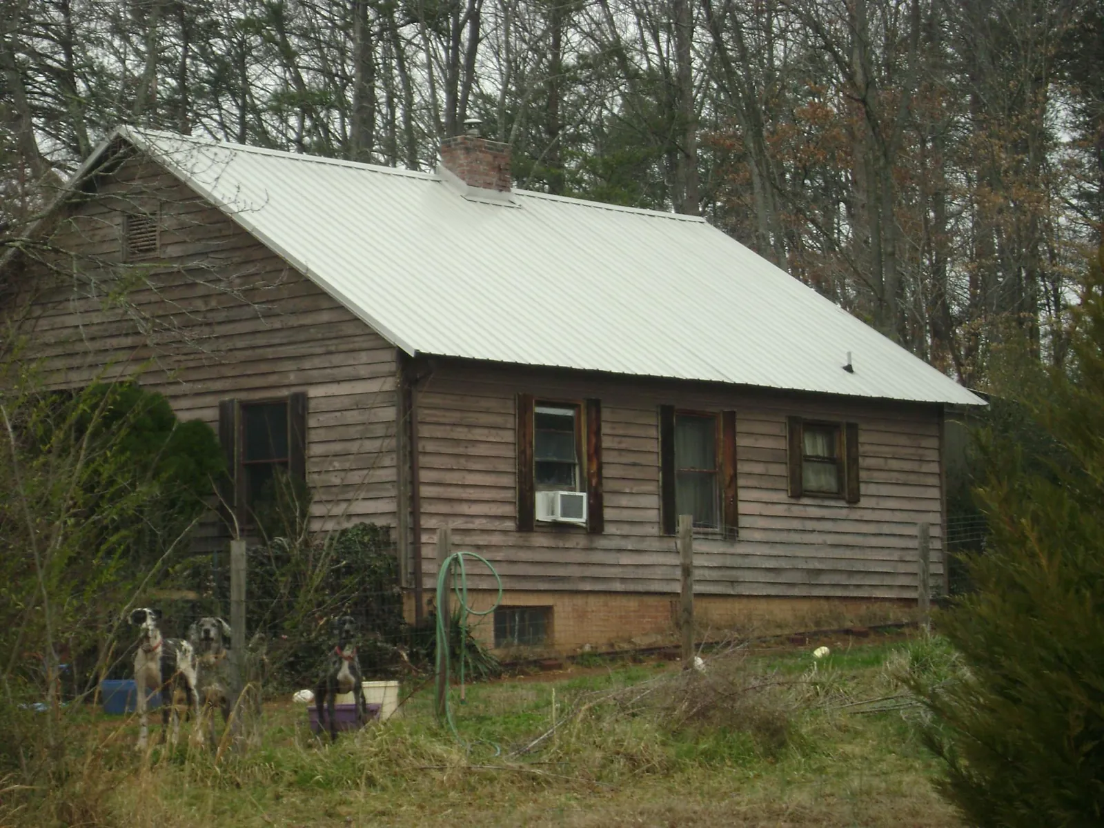 White metal roof on an old wood sided farmhouse, from a Asphalt Shingle Roof Repair job in Stanleytown